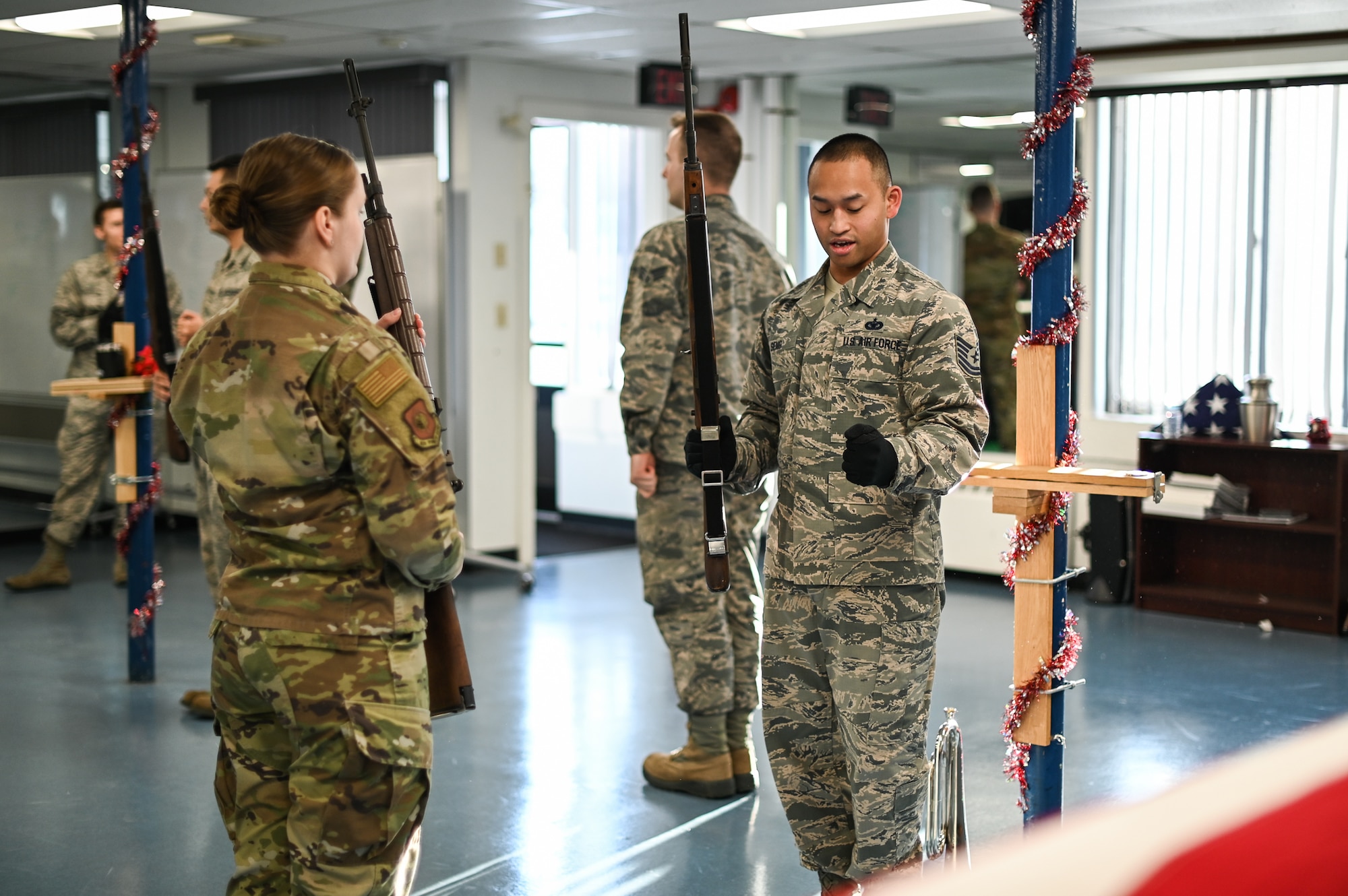 Tech. Sgt. David Seng, right, Patriot Honor Guard member, provides firing party instruction to 2nd Lt. Amanda Marciniak, an Honor Guard augmentee, during a training session at Hanscom Air Force Base, Mass., Dec. 12. The honor guard team provides funeral honor services in New England and Northeastern New York for active duty, retirees and veterans who served honorably in the United States Air Force. (U.S. Air Force photo by Mark Herlihy)