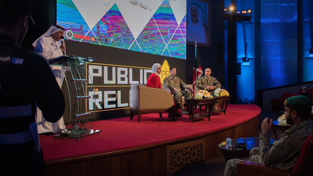 U.S. Air Force Capt. Thomas Barger, 386th Air Expeditionary Wing chief of public affairs, center, and Master Sgt. Daniel Ward, 386th Expeditionary Civil Engineer Squadron superintendent of emergency management, right, prepare to discuss elements of social media and crisis communication with a communications professor from the University of Kuwait during the Digital Public Relations Conference and Exhibition at the National LIbrary of Kuwait in Kuwait City, Dec. 11, 2019. "Digitalizing Strategic Communications for Confronting Public Relations Crisis" was the theme during this segment of the conference, which brought together U.S. military members to an audience of Kuwaiti government representatives, industry insiders, undergraduates, media and academics on effective crisis communication practices. (U.S. Air Force photo by Tech. Sgt. Daniel Martinez)