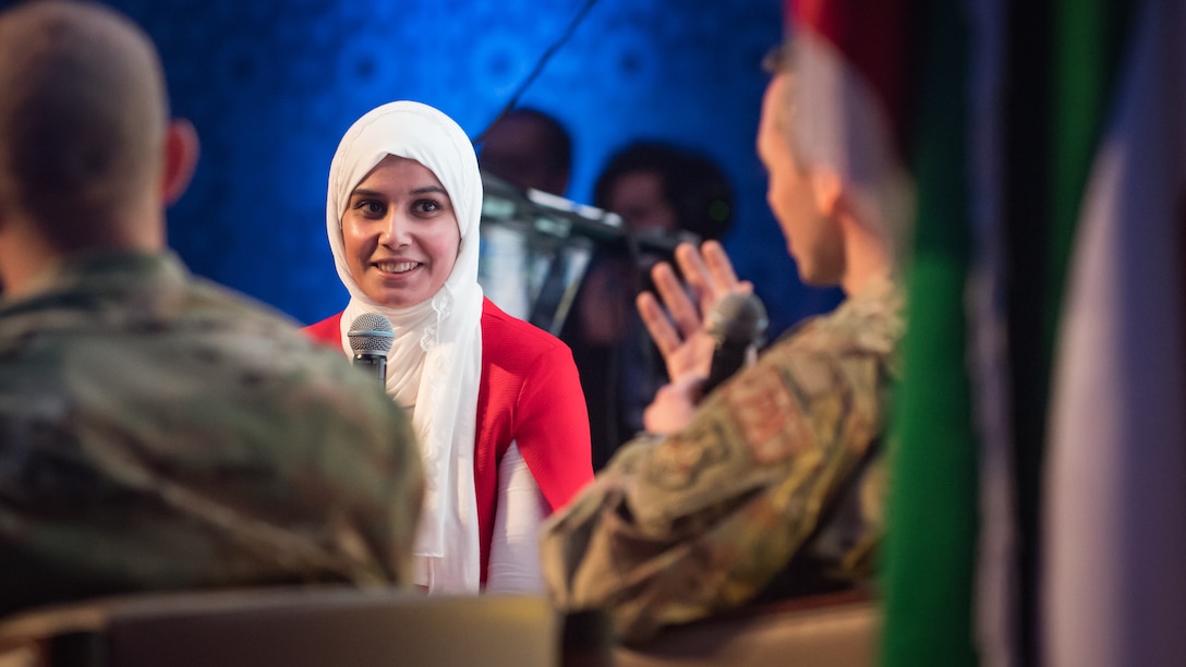 A communications professor from the University of Kuwait listens to U.S. Air Force Capt. Thomas Barger, 386th Air Expeditionary Wing chief of public affairs, right, and Master Sgt. Daniel Ward, 386th Expeditionary Civil Engineer Squadron superintendent of emergency management, left, during the Digital Public Relations Conference and Exhibition at the National LIbrary of Kuwait in Kuwait City, Dec. 11, 2019. "Digitalizing Strategic Communications for Confronting Public Relations Crisis" was the theme during this segment of the conference, which brought together U.S. military members to an audience of Kuwaiti government representatives, industry insiders, undergraduates, media and academics on effective crisis communication practices. (U.S. Air Force photo by Tech. Sgt. Daniel Martinez)