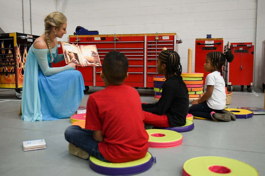 A woman dressed as the character Elsa from the animated film “Frozen,” reads to children at the children’s holiday party at RAF Mildenhall, England, Dec. 14, 2019. The children’s holiday party was hosted by the Mildenhall Spouses’ Association in partnership with the 100th Force Support Squadron to provide various holiday-themed activities for Team Mildenhall children and families.  (U.S. Air Force photo by Staff Sgt. Lexie West)