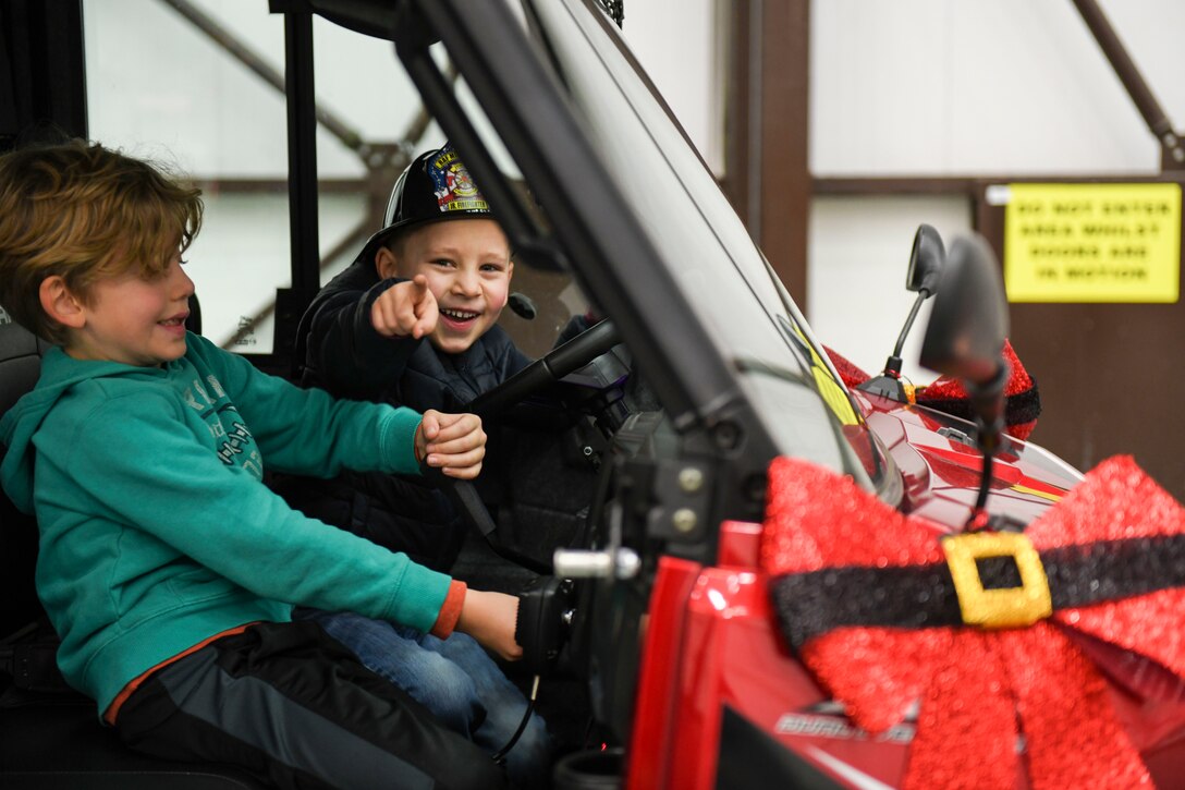 Children play inside of a security forces vehicle at the children’s holiday party at RAF Mildenhall, England, Dec. 14, 2019.  The children’s holiday party was hosted by the Mildenhall Spouses’ Association in partnership with the 100th Force Support Squadron to provide various holiday-themed activities for Team Mildenhall children and families. (U.S. Air Force photo by Staff Sgt. Lexie West)