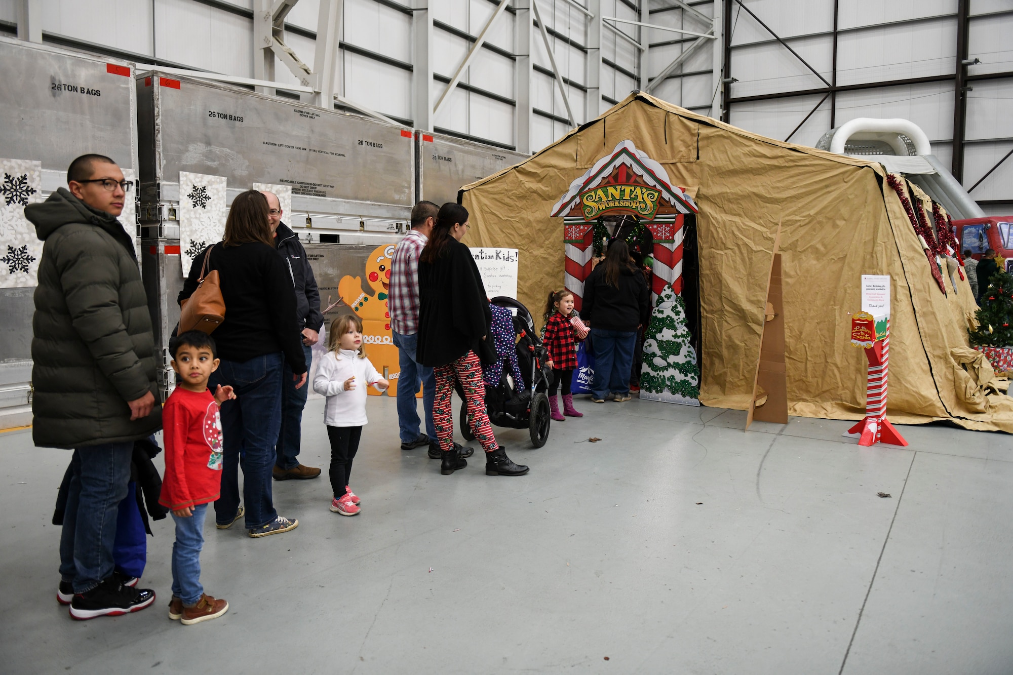 Team Mildenhall families wait to enter Santa’s Workshop at the children’s holiday party at RAF Mildenhall, England, Dec. 14, 2019. The event provided opportunities for children and families to celebrate the holiday season with crafts, games and food. (U.S. Air Force photo by Staff Sgt. Lexie West)
