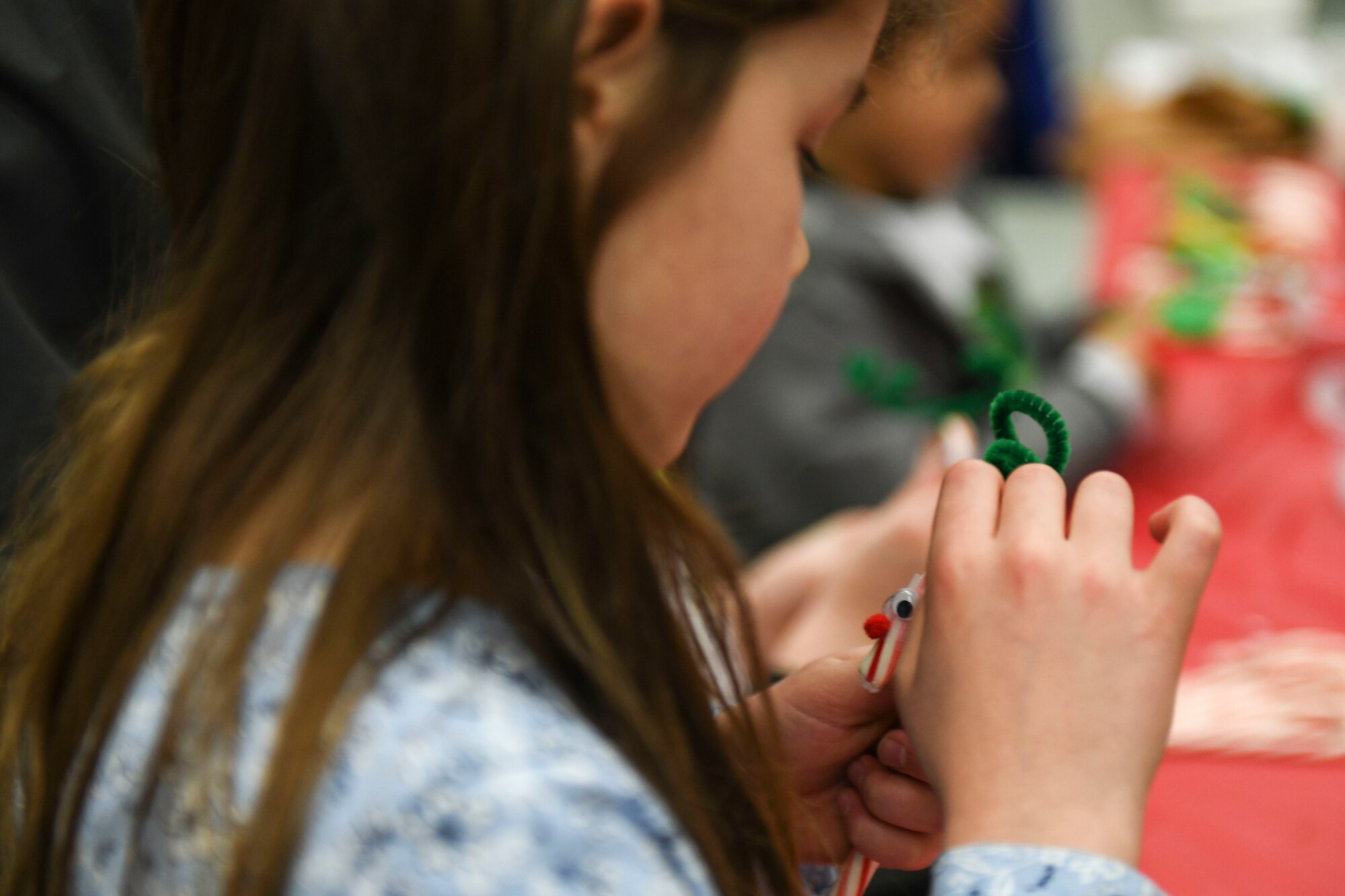 A Team Mildenhall child makes candy cane crafts at the children’s holiday party at RAF Mildenhall, England, Dec. 14, 2019. The event provided opportunities for children and families to celebrate the holiday season with crafts, games and food. (U.S. Air Force photo by Staff Sgt. Lexie West)