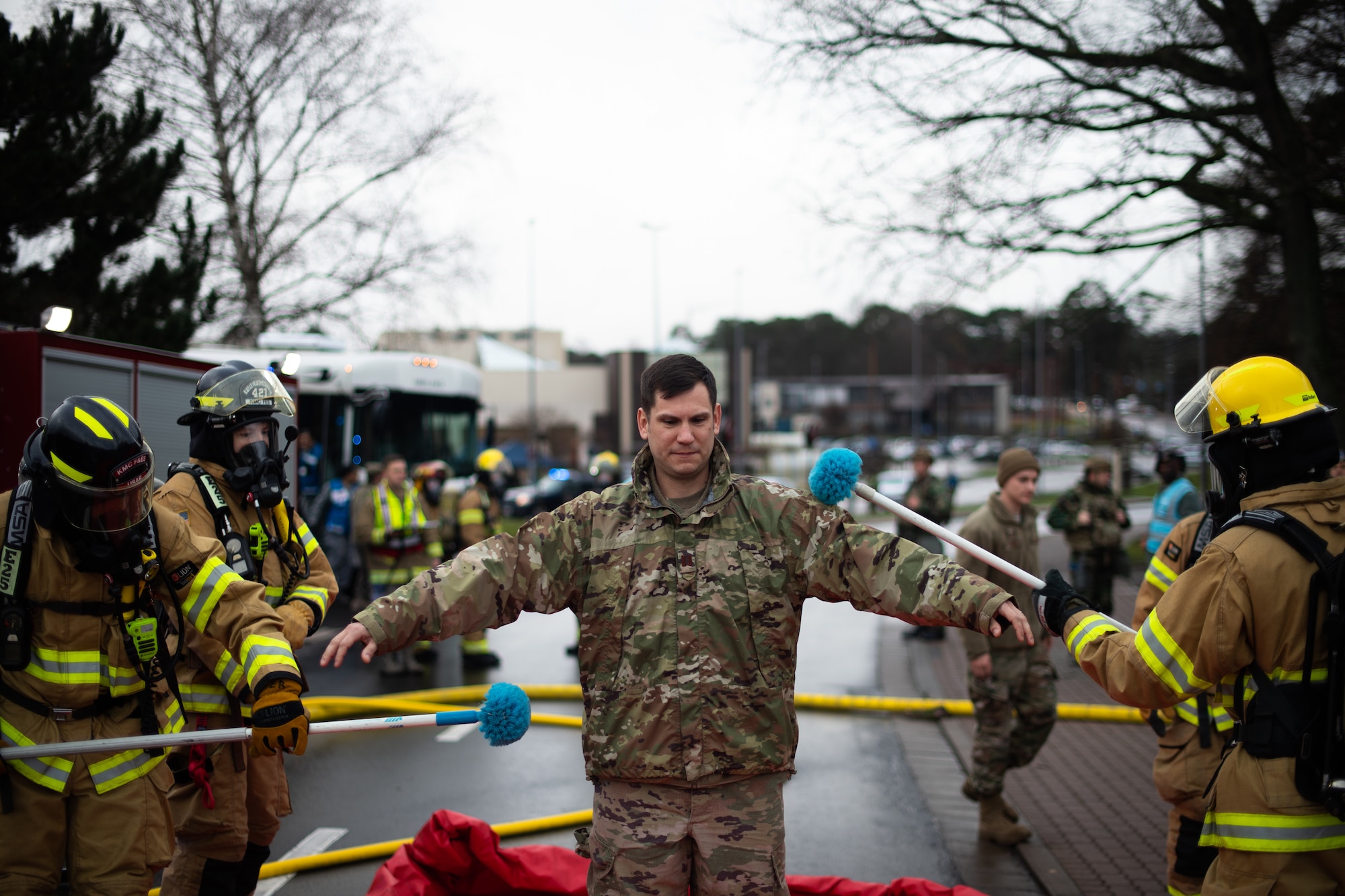 U.S. Air Force firefighters assigned to the 86th Civil Engineer Squadron simulate a decontamination line during exercise Operation Varsity 19-04, at Ramstein Air Base, Germany, Dec. 12, 2019. Operation Varsity is a reoccurring exercise designed to improve readiness when dealing with potential enemy threats and attacks. (U.S. Air Force photo by Staff Sgt. Devin Boyer)