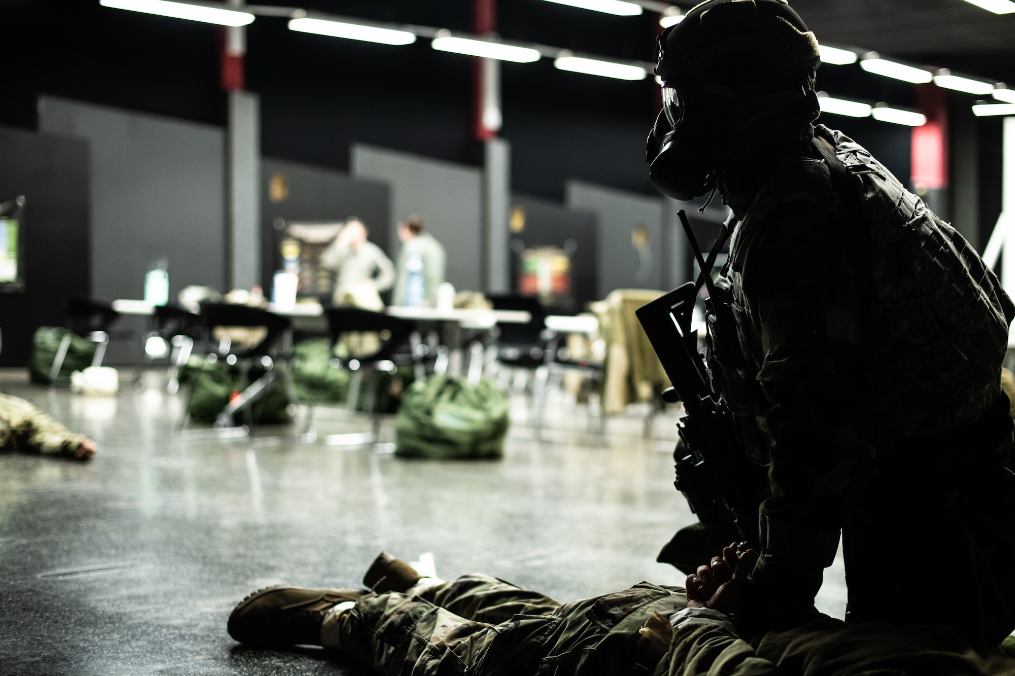 A U.S. Air Force Airman assigned to the 86th Security Forces Squadron detains an acting adversary during exercise Operation Varsity 19-04 at Ramstein Air Base, Germany, Dec. 12, 2019. The scenario simulated a chemical attack which affected multiple individuals who were then decontaminated by hazardous materials personnel. (U.S. Air Force photo by Staff Sgt. Devin Boyer)