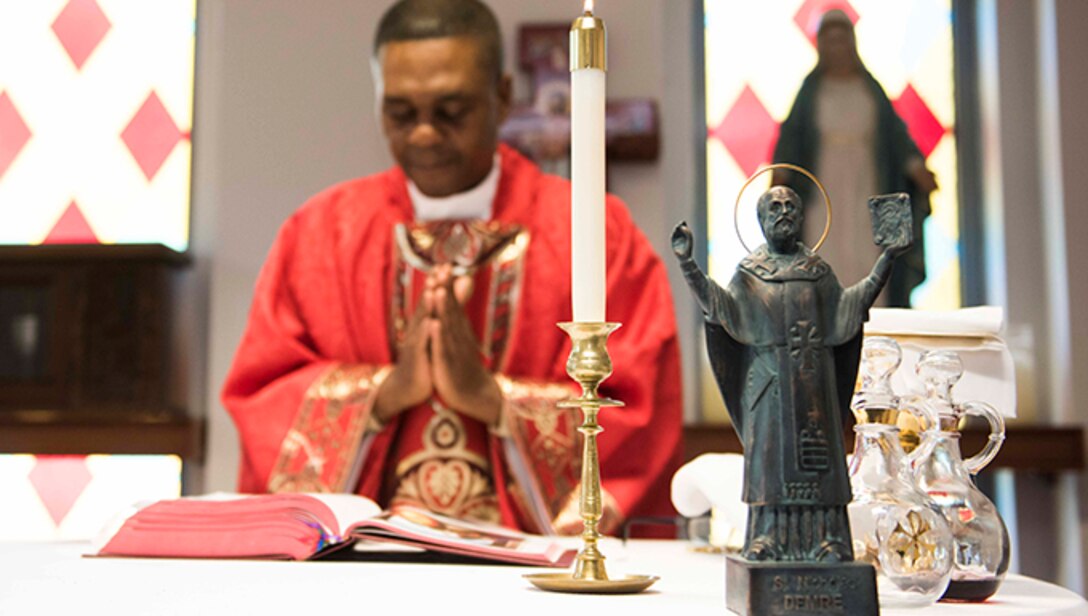 U.S. Air Force Maj. Paul Amaliri, 39th Air Base Wing deputy wing chaplain, celebrates a Catholic service in honor of St. Nicholas, whose statue stands on the altar Dec. 6, 2019, at Incirlik Air Base, Turkey. St. Nicholas served as a Christian bishop within the borders of modern-day Turkey and is the historical inspiration for the mythical Christmas figure, Santa Claus. (U.S. Air Force photo by Staff Sgt. Joshua Magbanua)