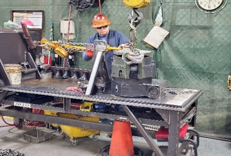 Greg A Patterson, Electronics Mechanic, M777A2 Howitzer Program, Production Plant Barstow, Marine Depot Maintenance Command utilizes the breech collar removal tool while at Marine Corps Logistics Base Barstow, California.  The breech collar tool and removal process were developed by the M777A2 team.