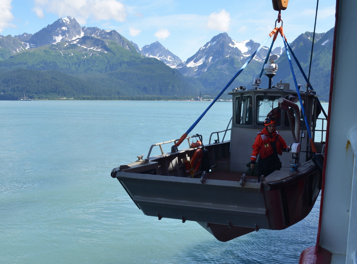 Petty Officer 3rd Class Danielle Ray from the Coast Guard Cutter Healy is lowered into Resurrection Bay near Seward, Alaska, July 21, 2017. Small boats aboard Healy are used as platforms for missions that include dive operations, scientific research and ice operations. U.S. Coast Guard photo by Senior Chief Petty Officer Rachel Polish