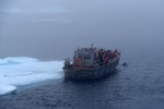 A small boat from the Coast Guard Cutter Healy is anchored to an ice floe during cold water ice dive operations in the Arctic Ocean, July 29, 2017. By conducting cold water ice dives in the Arctic and Antarctic, the Coast Guard has the ability to offer an adaptive force capability to the Polar Icebreaking fleet. U.S. Coast Guard photo by Senior Chief Petty Officer Rachel Polish