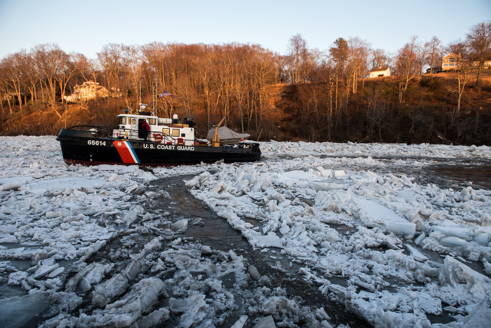 U.S. Coast Guard Cutter Bollard, a 65-foot Small Harbor Tug, transits on the ice-covered Connecticut River near Essex, Connecticut, Jan. 18, 2018. The Bollard is being used on the Connecticut River to break apart ice jams causing floods along the Connecticut River in support of Operation - Reliable Energy for Northeast Winters (RENEW). (U.S. Coast Guard photo by Petty Officer 3rd Class Frank Iannazzo-Simmons)