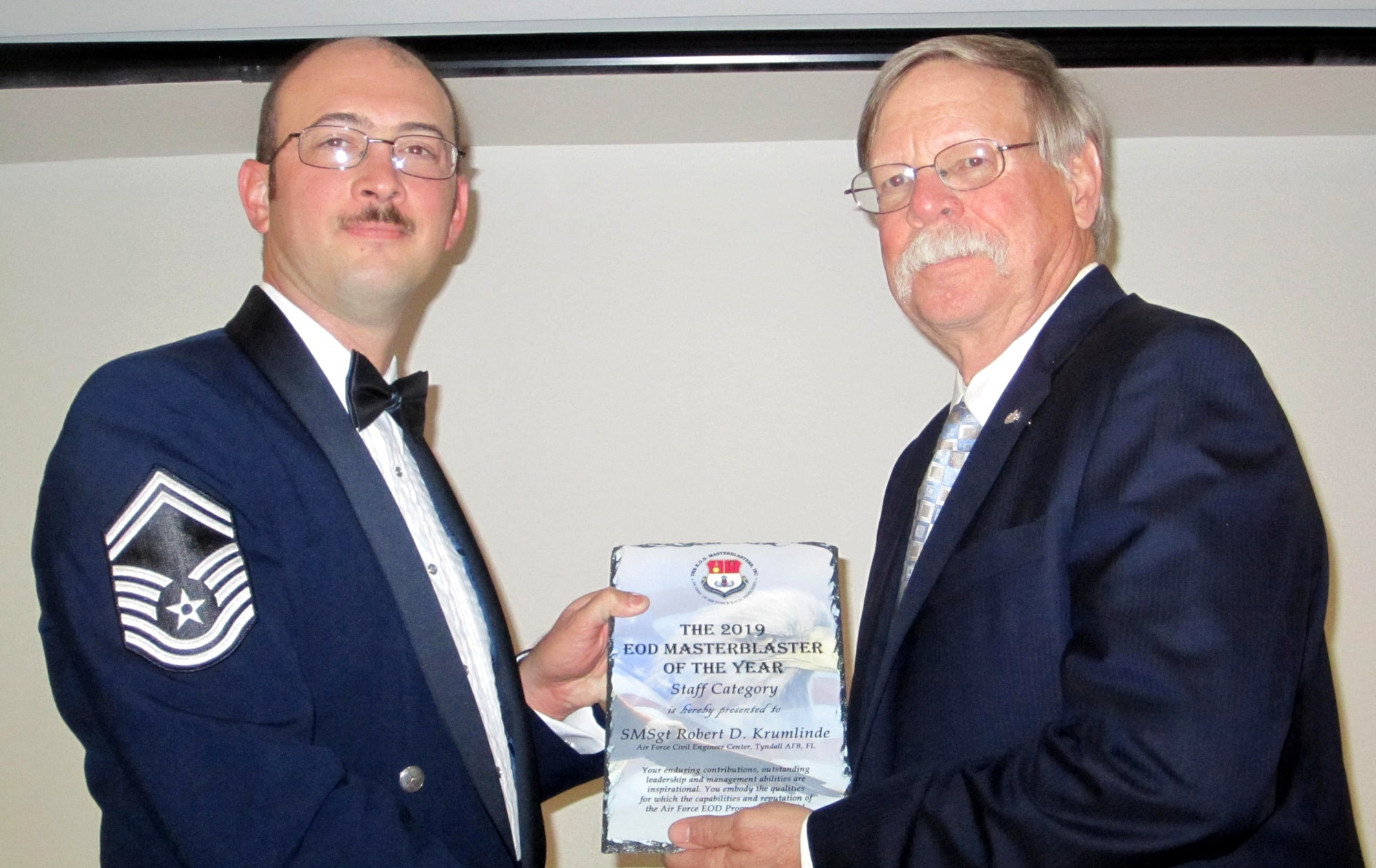 Senior Master Sgt. Robert D. Krumlinde, left, EOD Force Development manager, Air Force Civil Engineer Center, receives this year’s Staff Level Master Blaster award, at a ceremony held near Tyndall Air Force Base, Fla., Nov. 9, 2019.