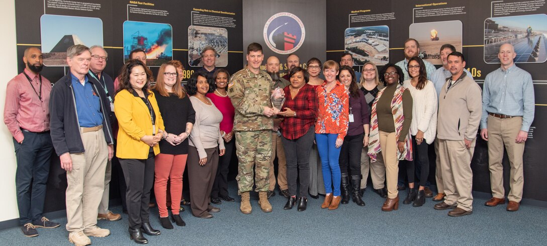Col. Marvin L. Griffin, commander of the U.S. Army Engineering and Support Center, Huntsville, Alabama, presents the 2019 U.S. Army Corps of Engineers’ “Team of the Year” Excellence in Contracting Award to members of the Fuels Recurring Maintenance and Minor Repair Project Delivery Team in Huntsville, Alabama, Dec. 16, 2019.
