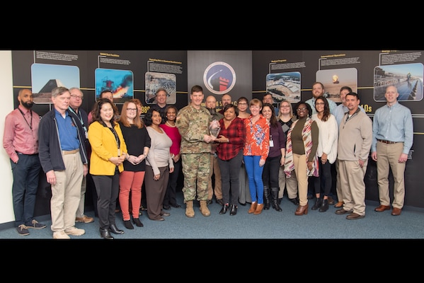 Col. Marvin L. Griffin, commander of the U.S. Army Engineering and Support Center, Huntsville, Alabama, presents the 2019 U.S. Army Corps of Engineers’ “Team of the Year” Excellence in Contracting Award to members of the Fuels Recurring Maintenance and Minor Repair Project Delivery Team in Huntsville, Alabama, Dec. 16, 2019.