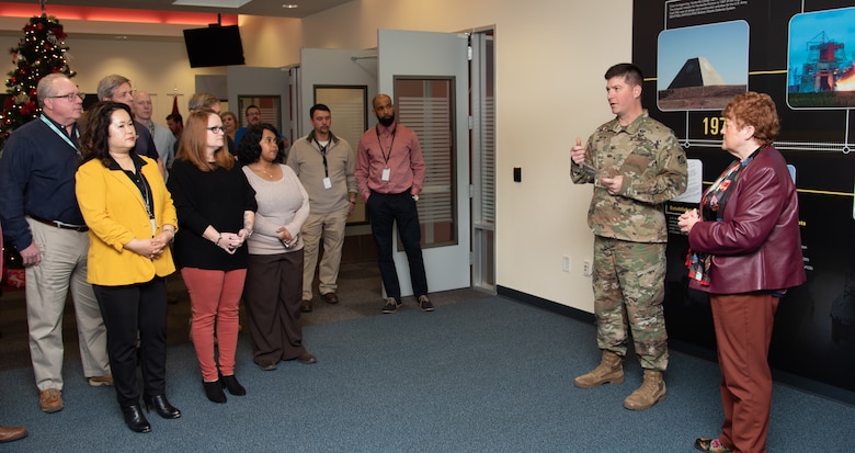 Col. Marvin L. Griffin, second from right, commander of the U.S. Army Engineering and Support Center, Huntsville, Alabama, thanks members of the Fuels Recurring Maintenance and Minor Repair Project Delivery Team Dec. 16, 2019, for the hard work that earned them the 2019 U.S. Army Corps of Engineers’ “Team of the Year” Excellence in Contracting Award, which Griffin presented to the team. At right is Colleen O'Keefe, who leads the Contracting Directorate at Huntsville Center.