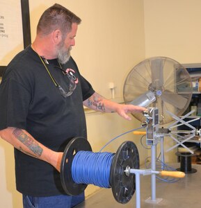 David Dean, 502nd Logistics Readiness Squadron munitions inspector, turns a spool winder as he threads cord through the counter on his team’s innovative design for revolutionizing the measuring of detonation and fuse cords at Joint Base San Antonio-Lackland Medina Annex Dec. 3, 2019. The team’s idea has been submitted to the Air Force Installation and Mission Support Center’s Call for Innovation Topics competition.