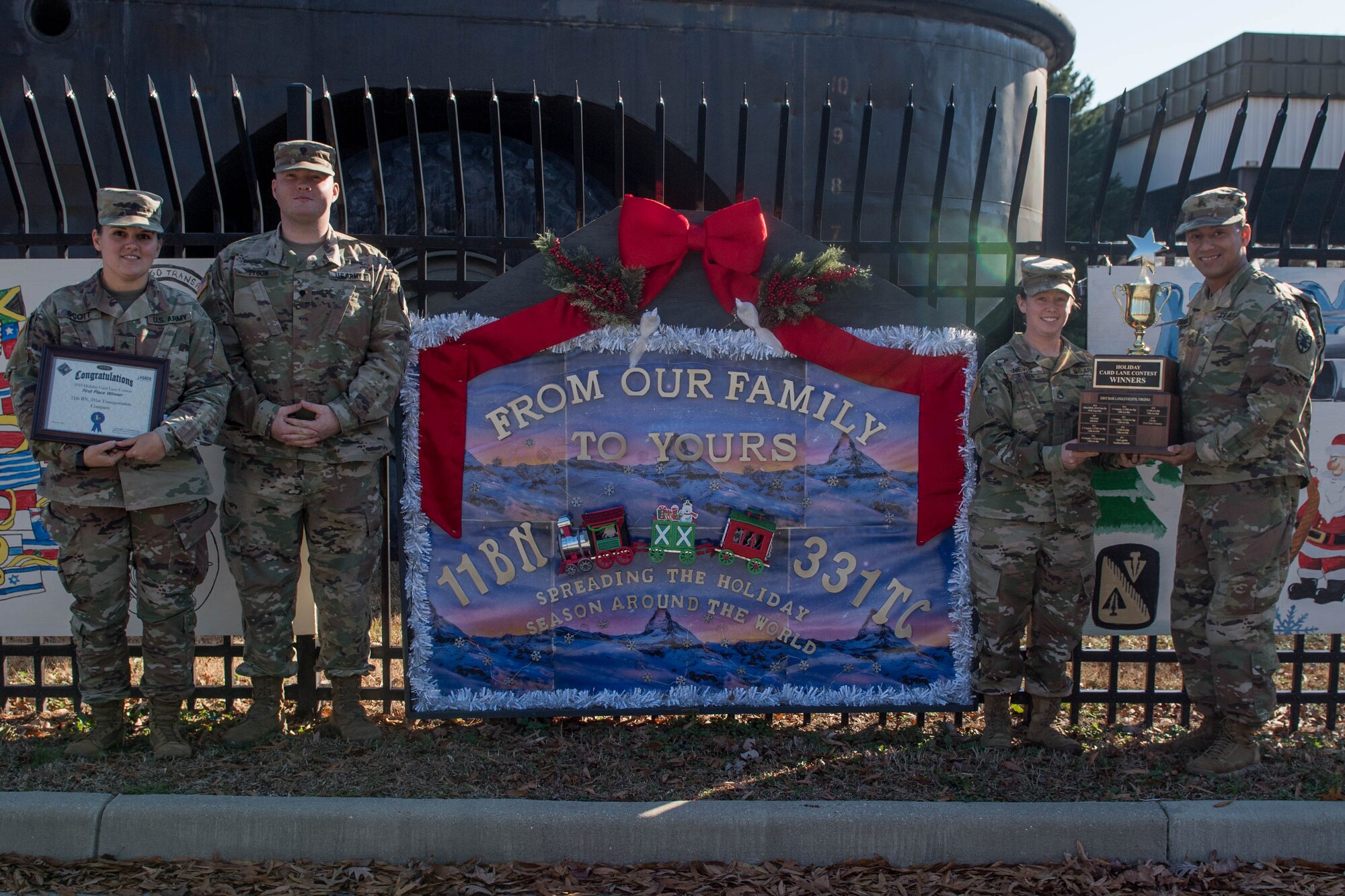 U.S. Army Soldiers assigned to the 331st Transportation Company, 11th Trans. Battalion, 7th Trans. Brigade (Expeditionary), pose after winning the Holiday Card Lane competition at Joint Base Langley-Eustis, Virginia, Dec. 12, 2019. The theme for 2019 was “Holidays Around the World”. (U.S. Air Force photo by Senior Airman Derek Seifert)