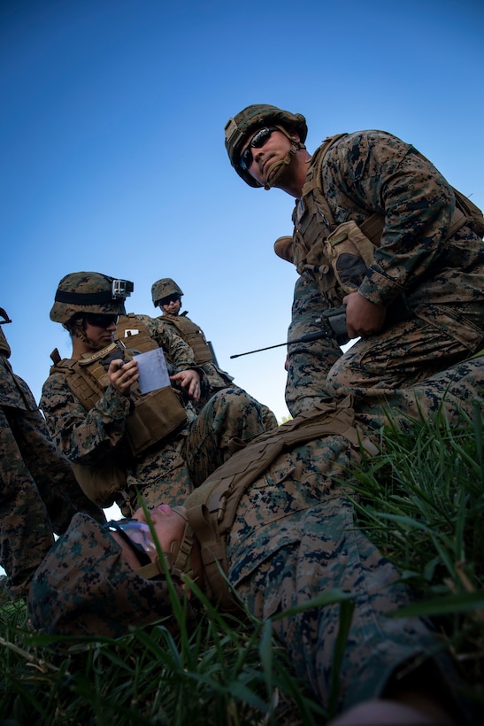 U.S. Marines with Headquarters Battalion (HQBN), Marine Corps Base Hawaii (MCBH), conduct a 9-line transmission, Marine Corps Training Area, Bellows, Dec. 11, 2019. Marines with Headquarters Battalion, Marine Corps Base Hawaii executed 9-line transmissions, casualty response exercises, and casualty evacuations with the assistance of VMM-268 to increase their readiness. (U.S. Marine Corps photo by Lance Cpl. Samantha Sanchez)