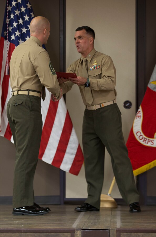 U.S. Marine Gunnery Sgt. Daniel Best, the Marine Security Guard detachment commander for the U.S. Embassy in Bogota, Colombia, receives his diploma during the Expeditionary Warfare School Blended Seminar Program graduation ceremony at the Center for Naval Aviation Technical Training auditorium on Marine Corps Base Camp Pendleton, California, Dec. 13, 2019. Best was the first staff noncommissioned officer to attend the program. (U.S. Marine Corps photo by Lance Cpl. Andrew Cortez)