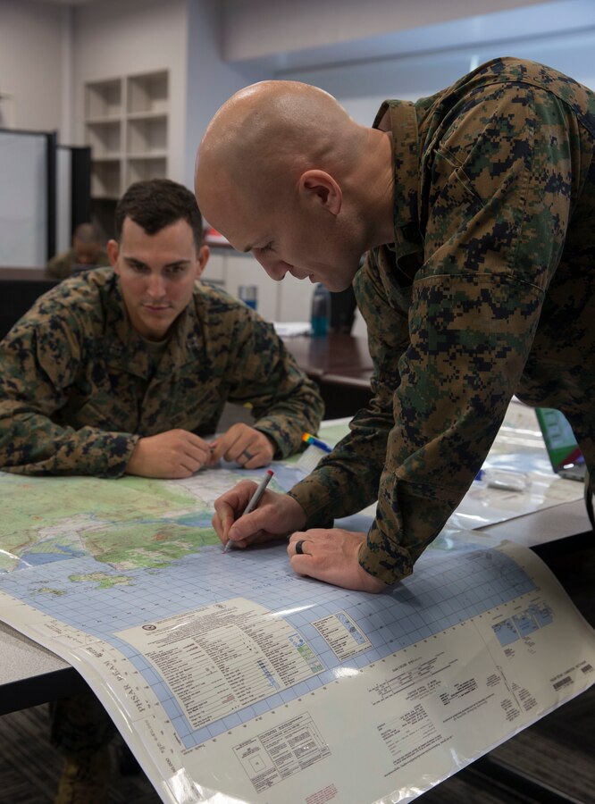 U.S. Marine Gunnery Sgt. Daniel Best, the Marine Security Guard detachment commander for the U.S. Embassy in Bogota, Colombia, plots points on a map during the Expeditionary Warfare School Blended Seminar Program on Marine Corps Base Camp Pendleton, California, Dec. 11, 2019. Best was the first staff noncommissioned officer to attend the program and graduated Dec. 13. (U.S. Marine Corps photo by Lance Cpl. Andrew Cortez)