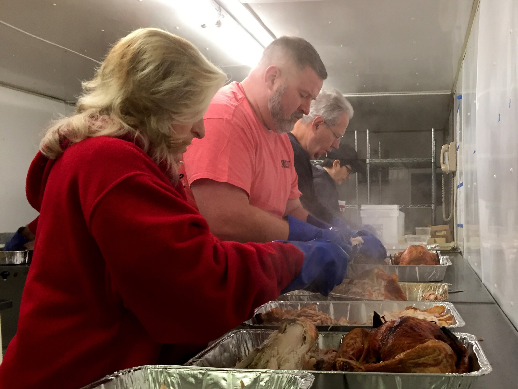 Volunteers prepare food for the Feed the Troops event at Dover Downs in Dover, Del., Dec. 17, 2019. Food served during the event was donated by the community and local businesses. (U.S. Air Force photo by Roland Balik)