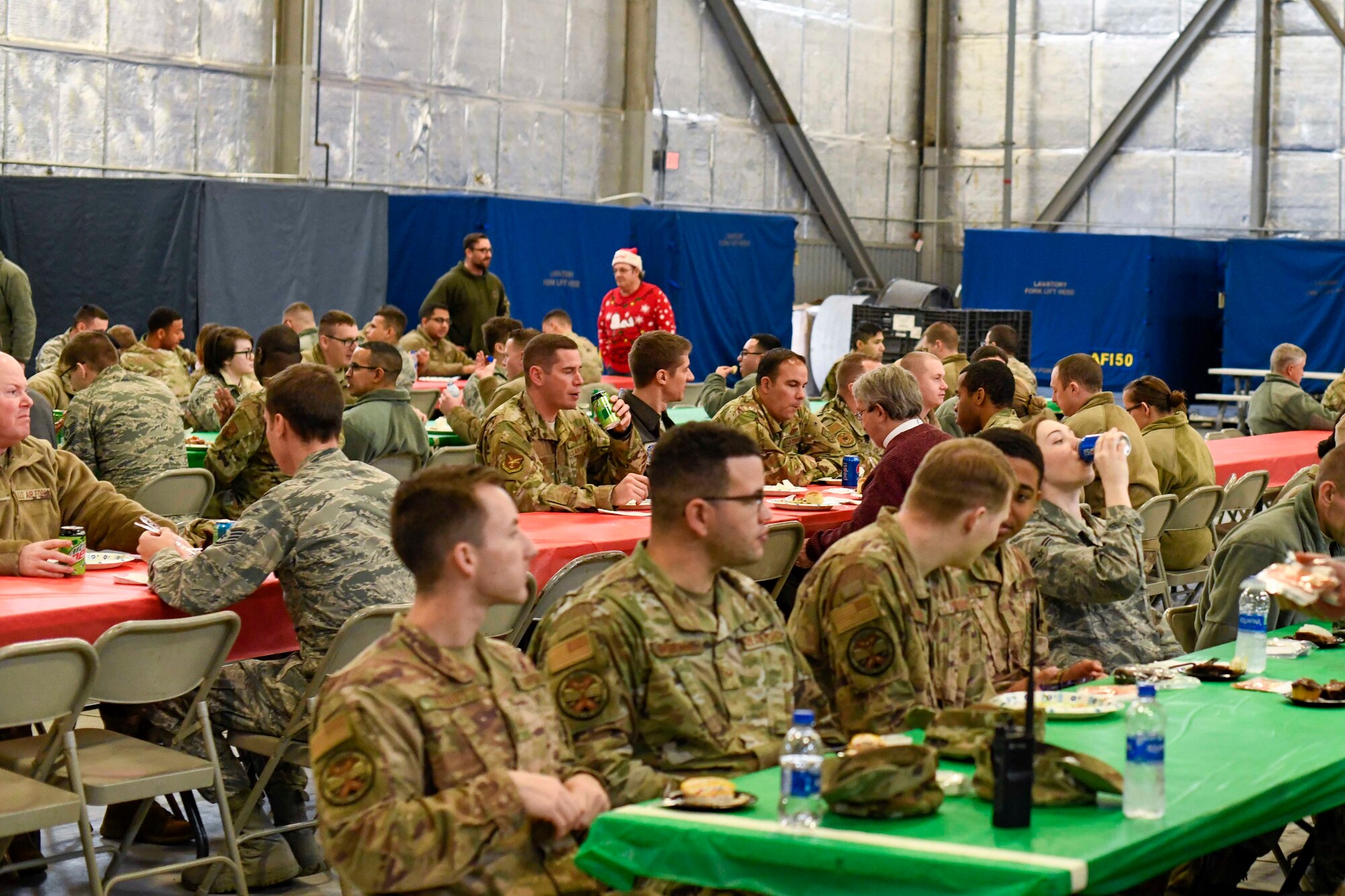 Airmen converse during the Feed the Troops event at Dover Air Force Base, Del., Dec. 17, 2019. Each year Airmen attend the community-sponsored event, which started in 2004. (U.S. Air Force photo by Senior Airman Eric M. Fisher)