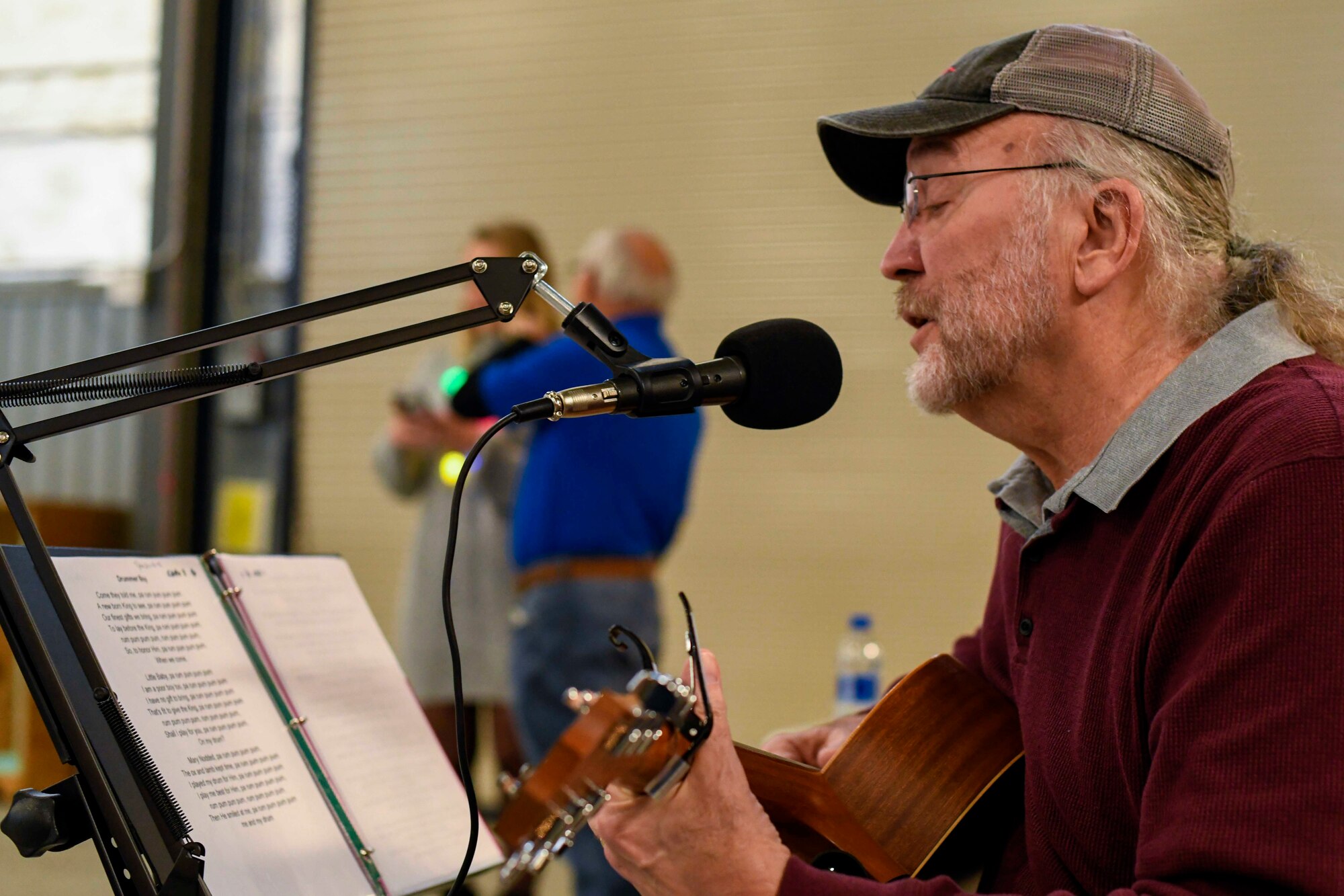 Tom Hench, a local musician, plays guitar during the Feed the Troops event at Dover Air Force Base, Del., Dec. 17, 2019. Airmen and their families were greeted with food, music and Santa Claus during the event. (U.S. Air Force photo by Senior Airmen Eric M. Fisher)