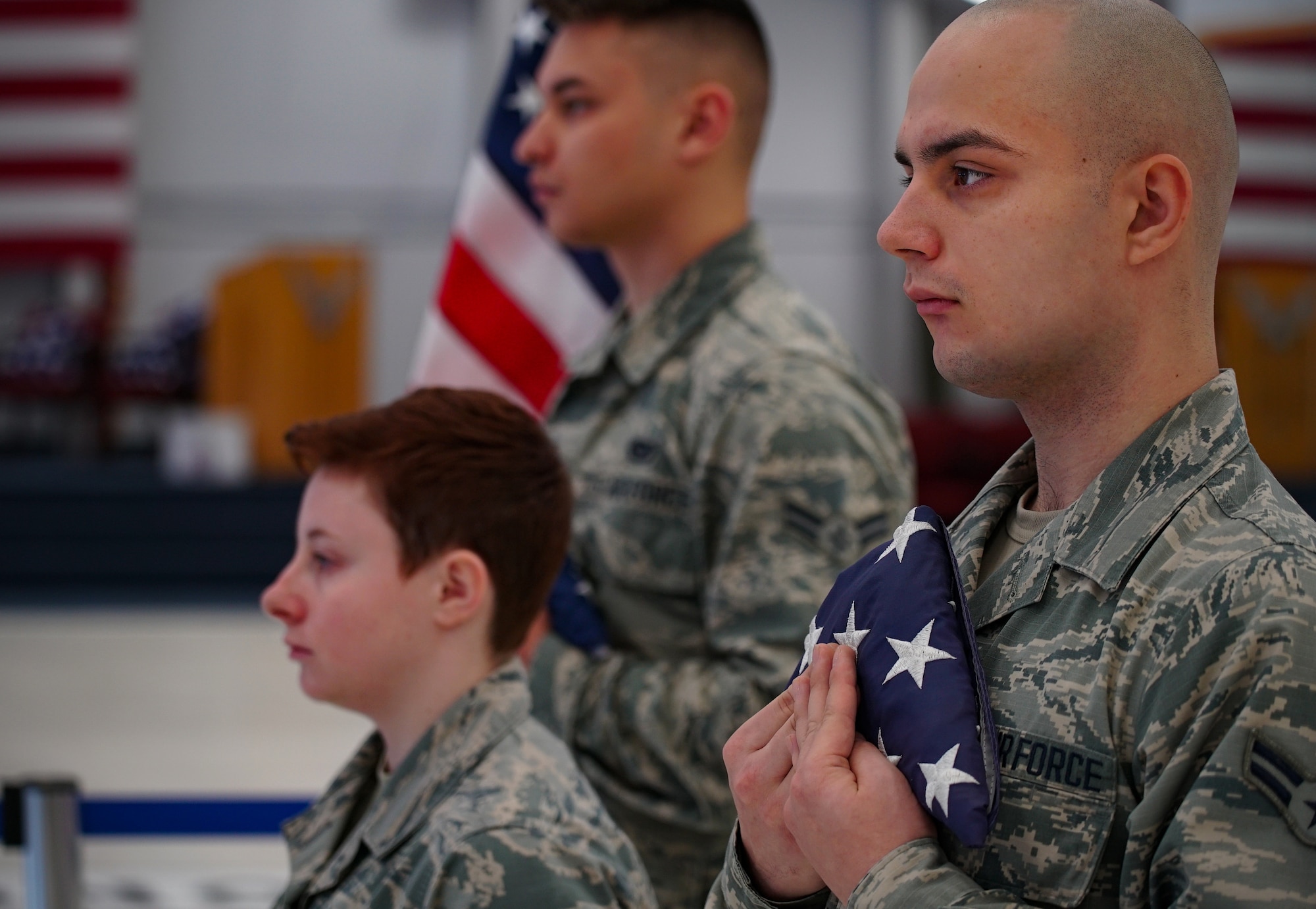Base honor guardsmen present flags for review prior to a ceremonial burn Dec. 7, 2019, on Grand Forks Air Force Base, North Dakota. Nearly 50 flags from the local community and base were burned in the ceremony after being deemed faded, worn or otherwise unserviceable by the local chapter of the American Legion. (U.S. Air Force photo by Senior Airman Elora J. Martinez)