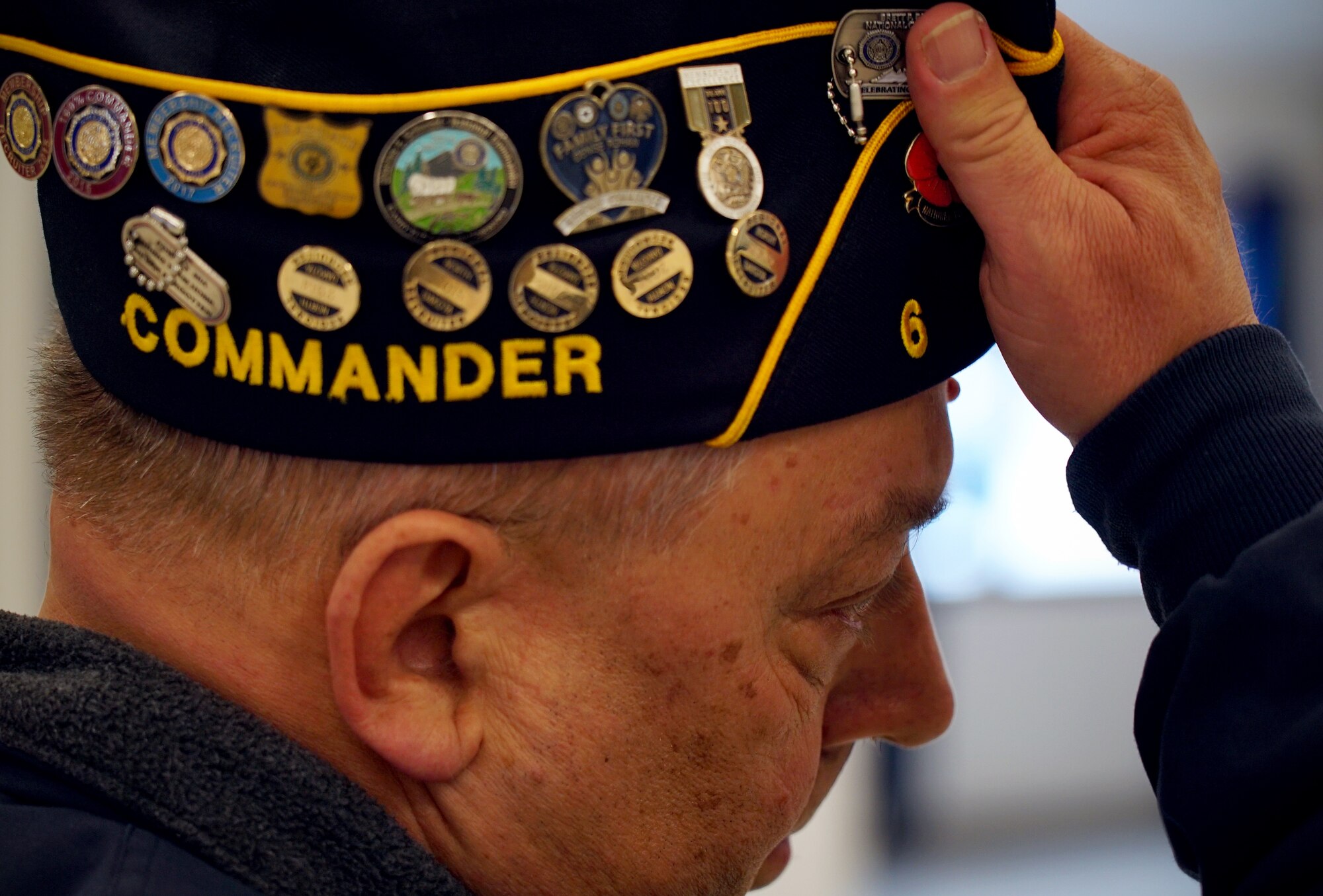 Robert Greene, American Legion Post 6 commander, removes his cap to offer respect during a ceremony for disposal of unserviceable flags Dec. 7, 2019, on Grand Forks Air Force Base, North Dakota. Greene’s American Legion post recruited the help of the base honor guard team to conduct the ceremony and ceremonial burning of nearly 50 faded, worn or otherwise unserviceable flags flown in the local community prior to being retired. (U.S. Air Force photo by Senior Airman Elora J. Martinez)