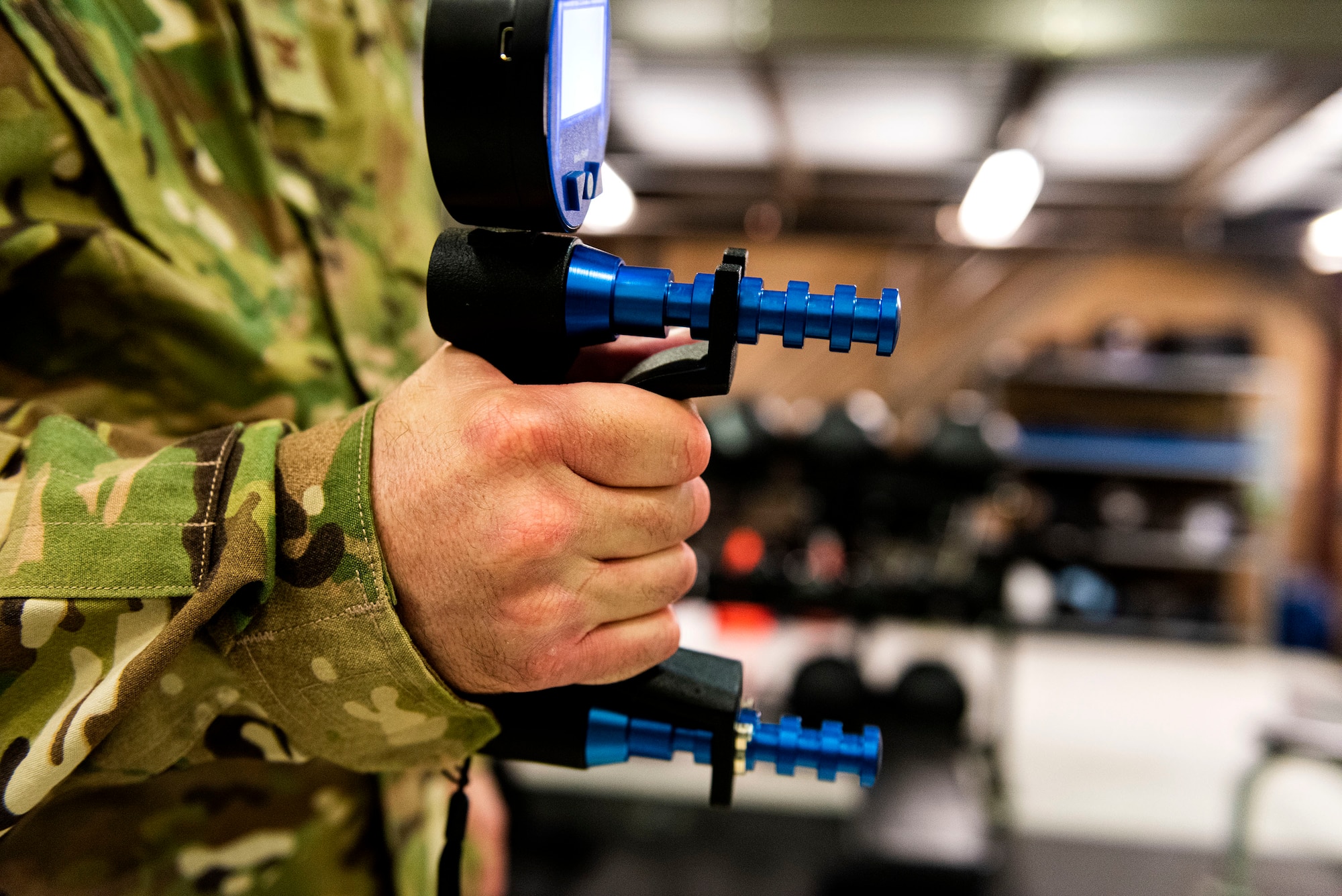 A photo of Col. Dan Walls practices using a handgrip dynamometer.