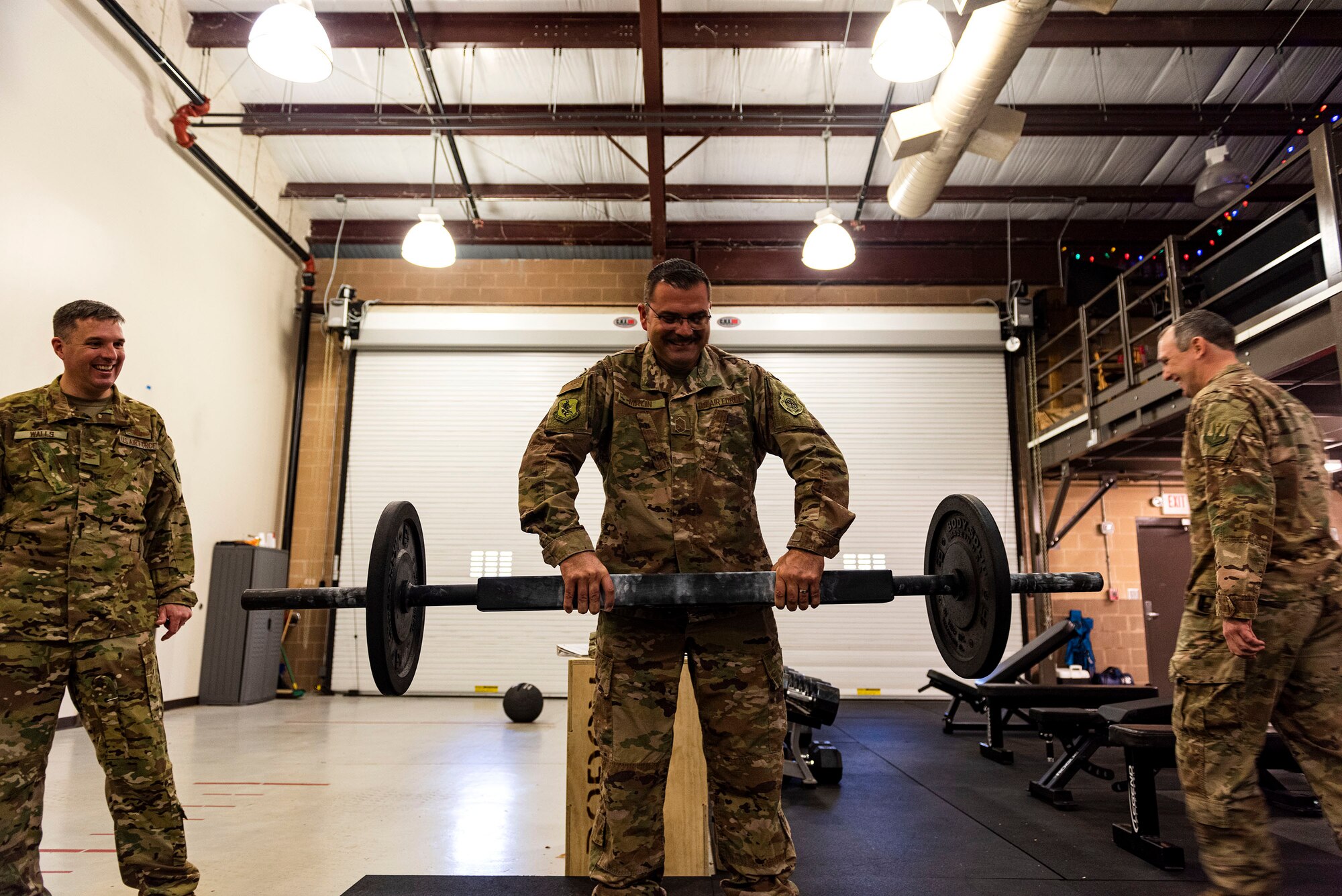 A photo of Chief Master Sgt. Chadd Malin lifting a rogue square bar.