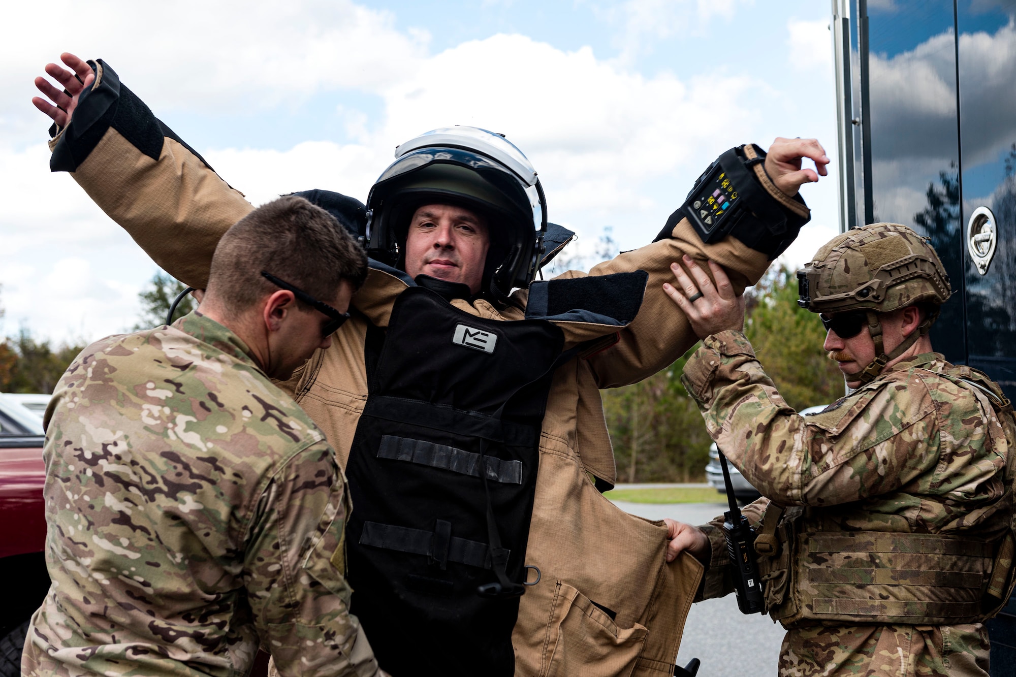 A photo of Airmen assigned to the 23d CES EOD flight putting on an EOD 9 bomb suit on Col. Dan Walls.