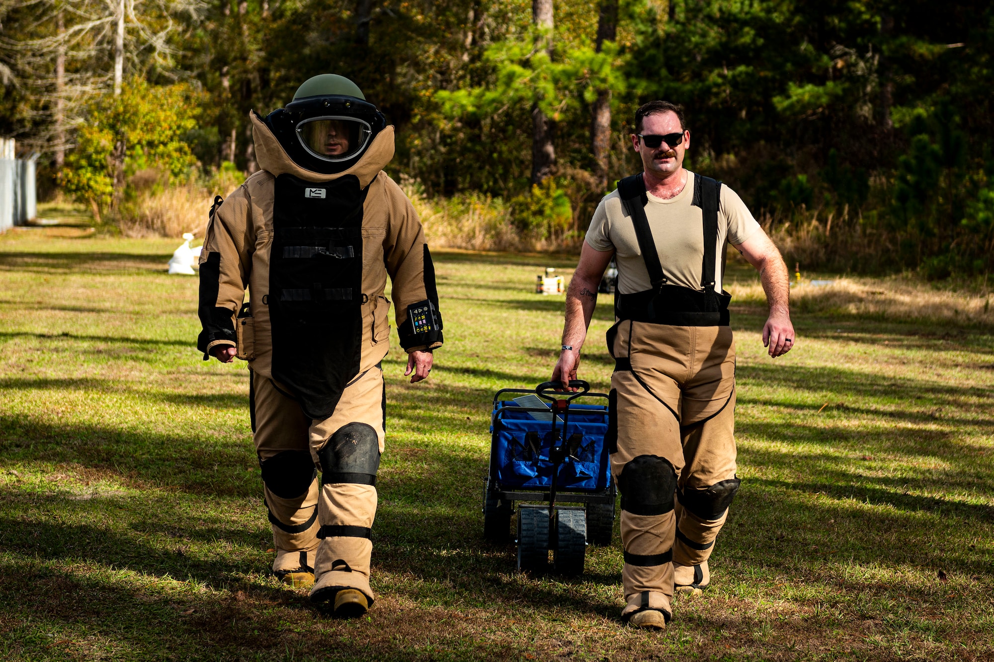 A photo of Airmen walking away from a training IED.
