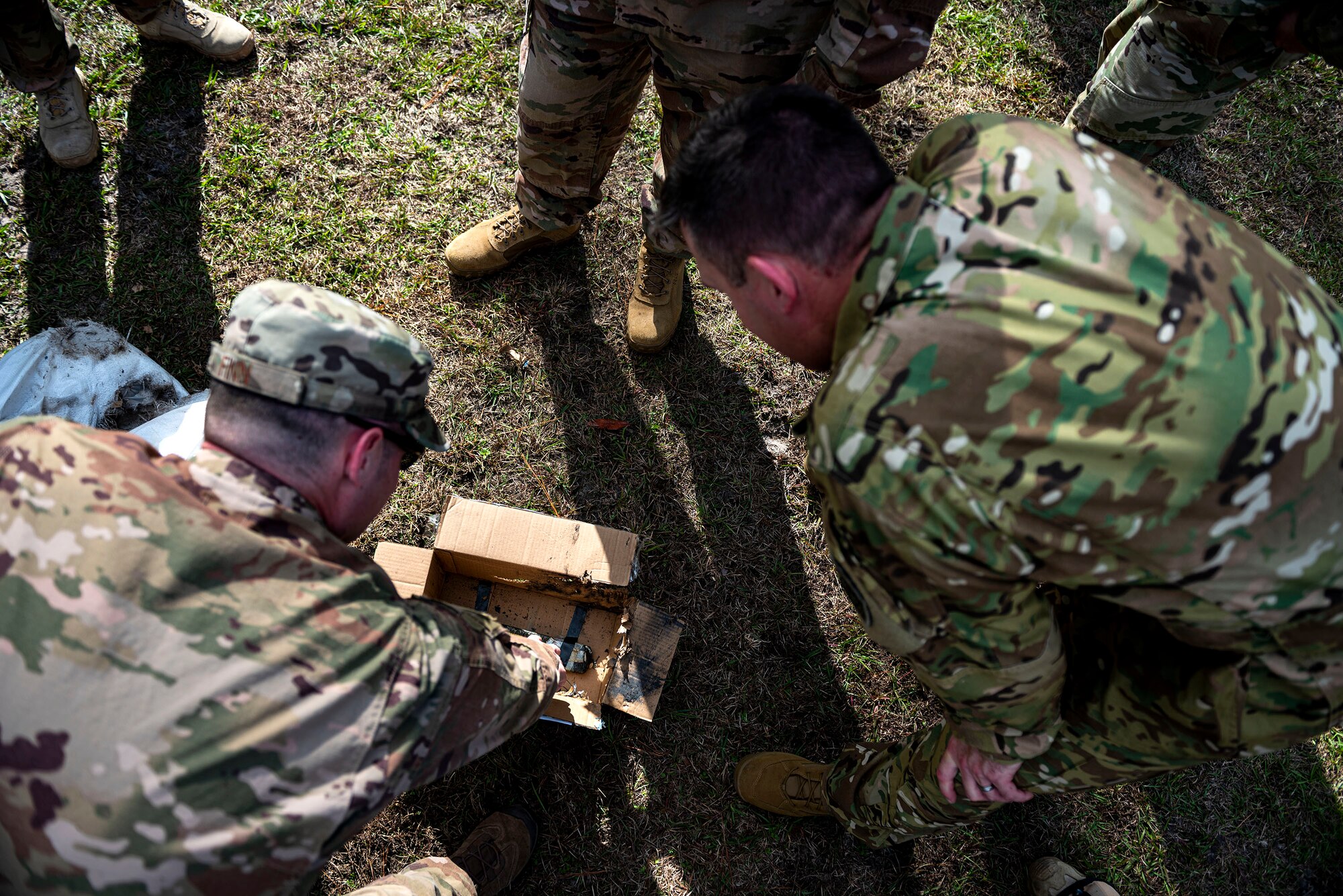 A photo of 23d Wing leadership verifying the remains of a training IED.