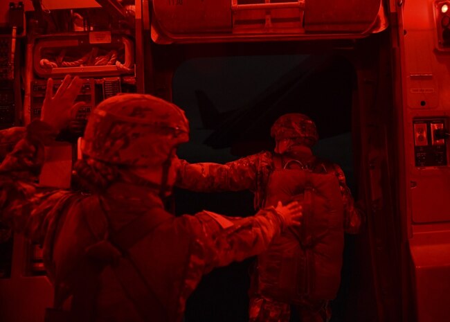 Two people simulate jumping out of an aircraft.