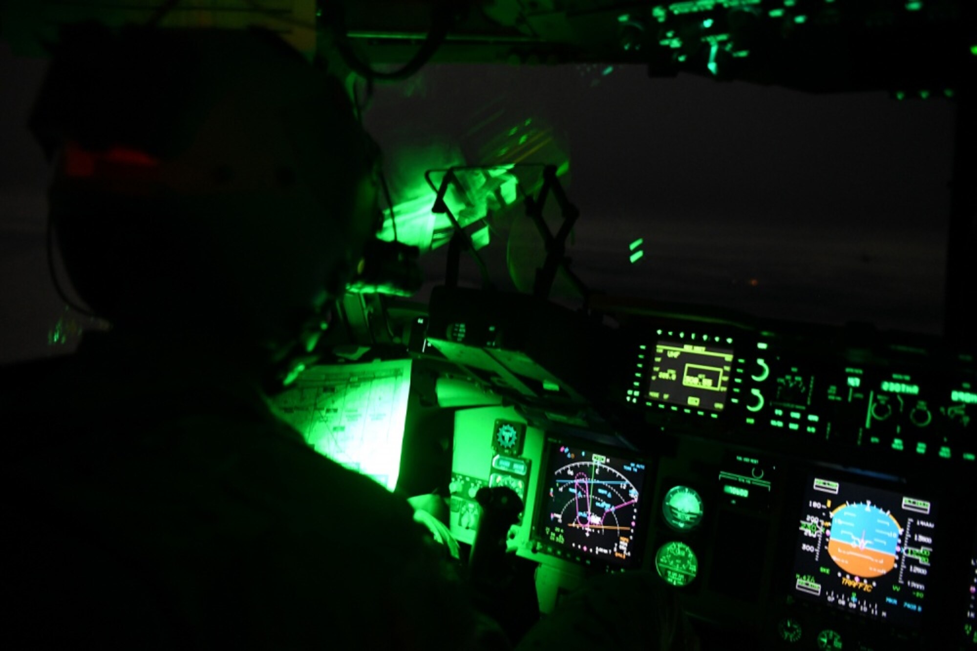 A person sits in the cockpit of an aircraft.