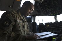 A person sits in the cock pit of an aircraft