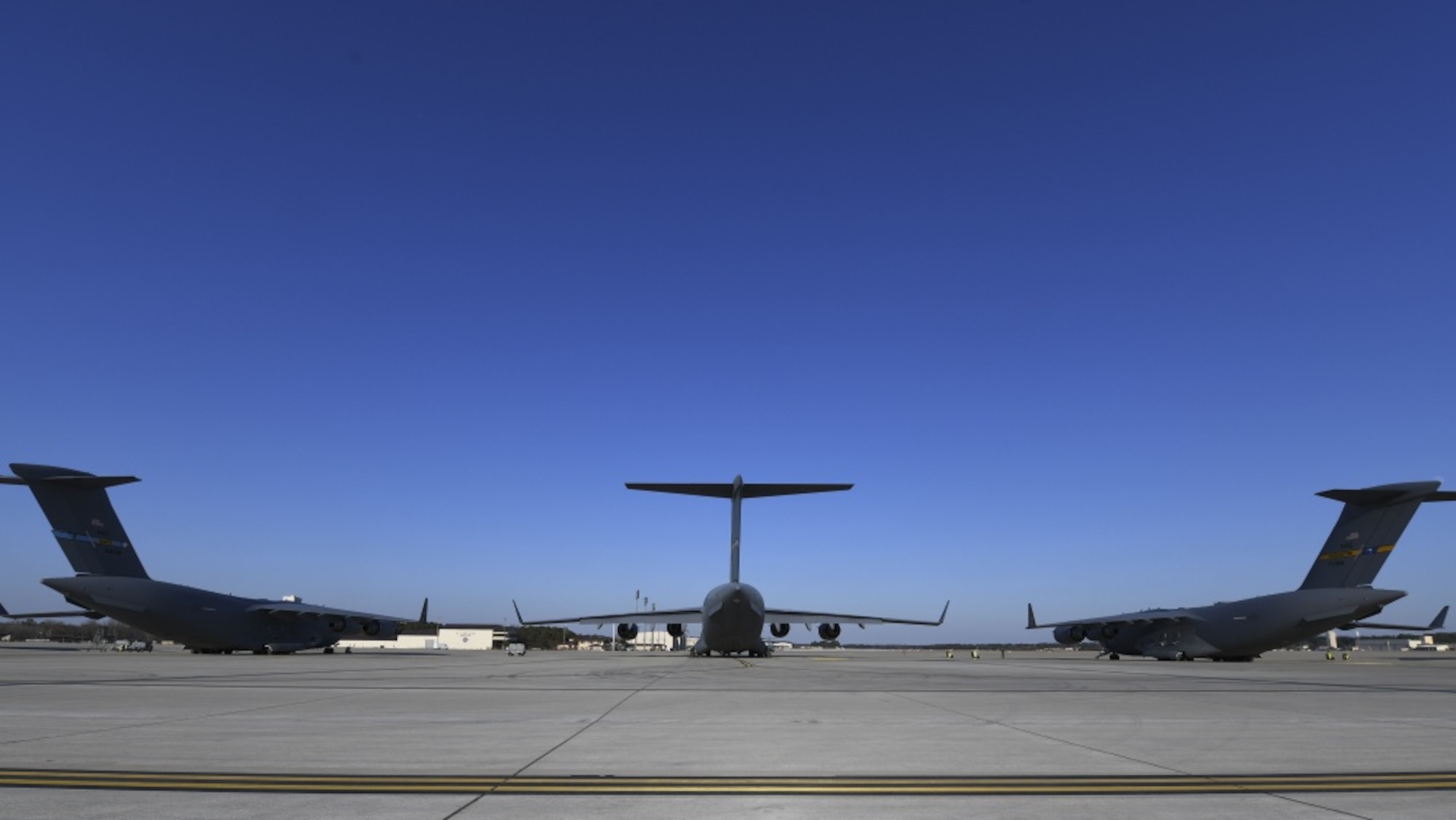 Three C-17 aircraft sit on a flightline.