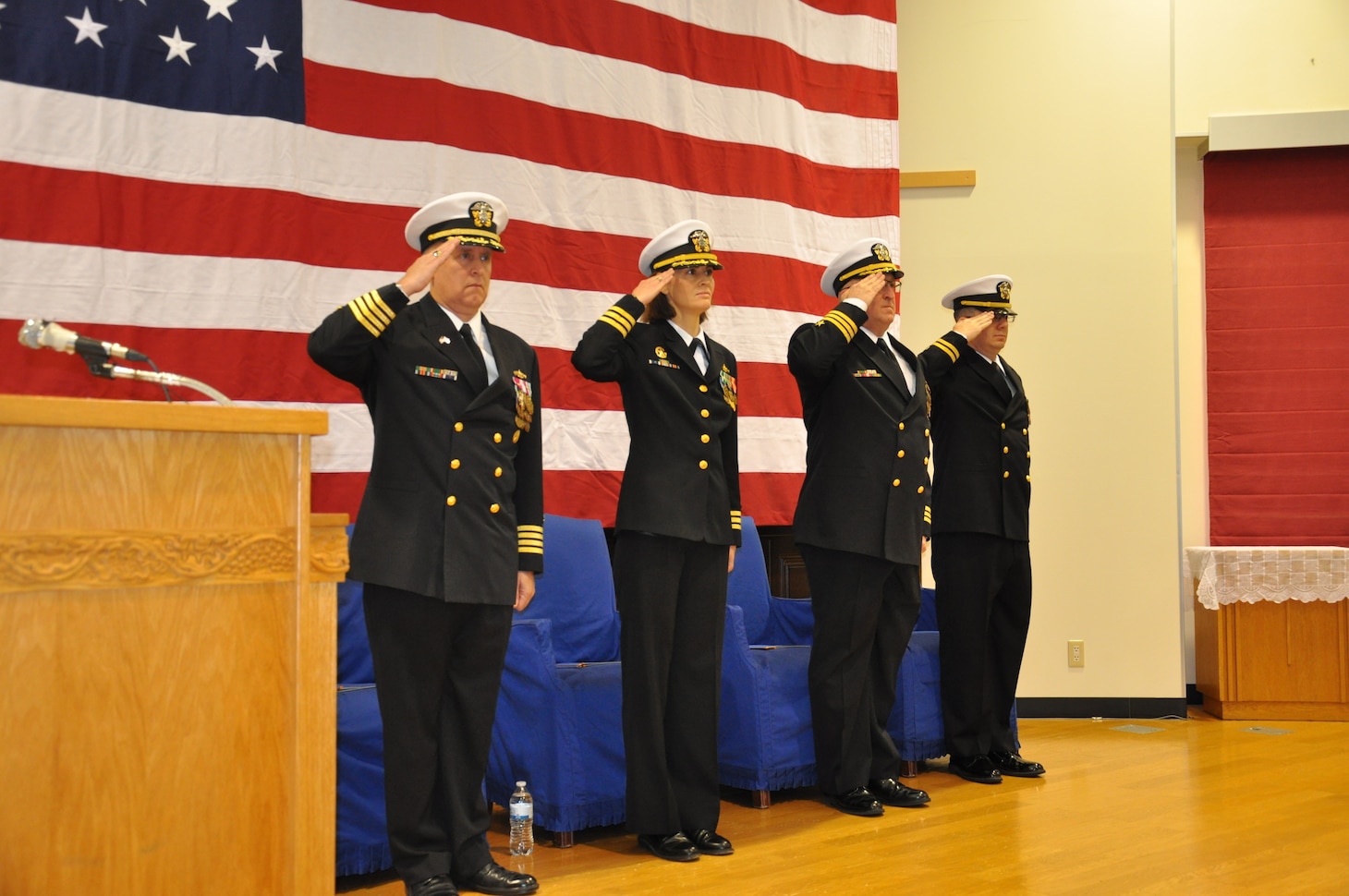 SASEBO, Japan (Dec. 12, 2019) The official party renders hand salutes to the American and Japanese ensigns during the change of command ceremony for Naval Beach Unit (NBU) 7 onboard Commander, Fleet Activities Sasebo. Cmdr. Kirk Sowers relieved Cmdr. Greta Densham as commanding officer of NBU 7, which serves as the training and readiness command for landing craft, air cushions, landing craft utilities, and beach party teams forward-deployed in Japan. NBU 7, part of Expeditionary Strike Group (ESG) 7, is operating in the Indo-Pacific region to enhance interoperability with partners and serve as a ready-response force for any type of contingency.