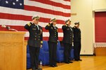 SASEBO, Japan (Dec. 12, 2019) The official party renders hand salutes to the American and Japanese ensigns during the change of command ceremony for Naval Beach Unit (NBU) 7 onboard Commander, Fleet Activities Sasebo. Cmdr. Kirk Sowers relieved Cmdr. Greta Densham as commanding officer of NBU 7, which serves as the training and readiness command for landing craft, air cushions, landing craft utilities, and beach party teams forward-deployed in Japan. NBU 7, part of Expeditionary Strike Group (ESG) 7, is operating in the Indo-Pacific region to enhance interoperability with partners and serve as a ready-response force for any type of contingency.