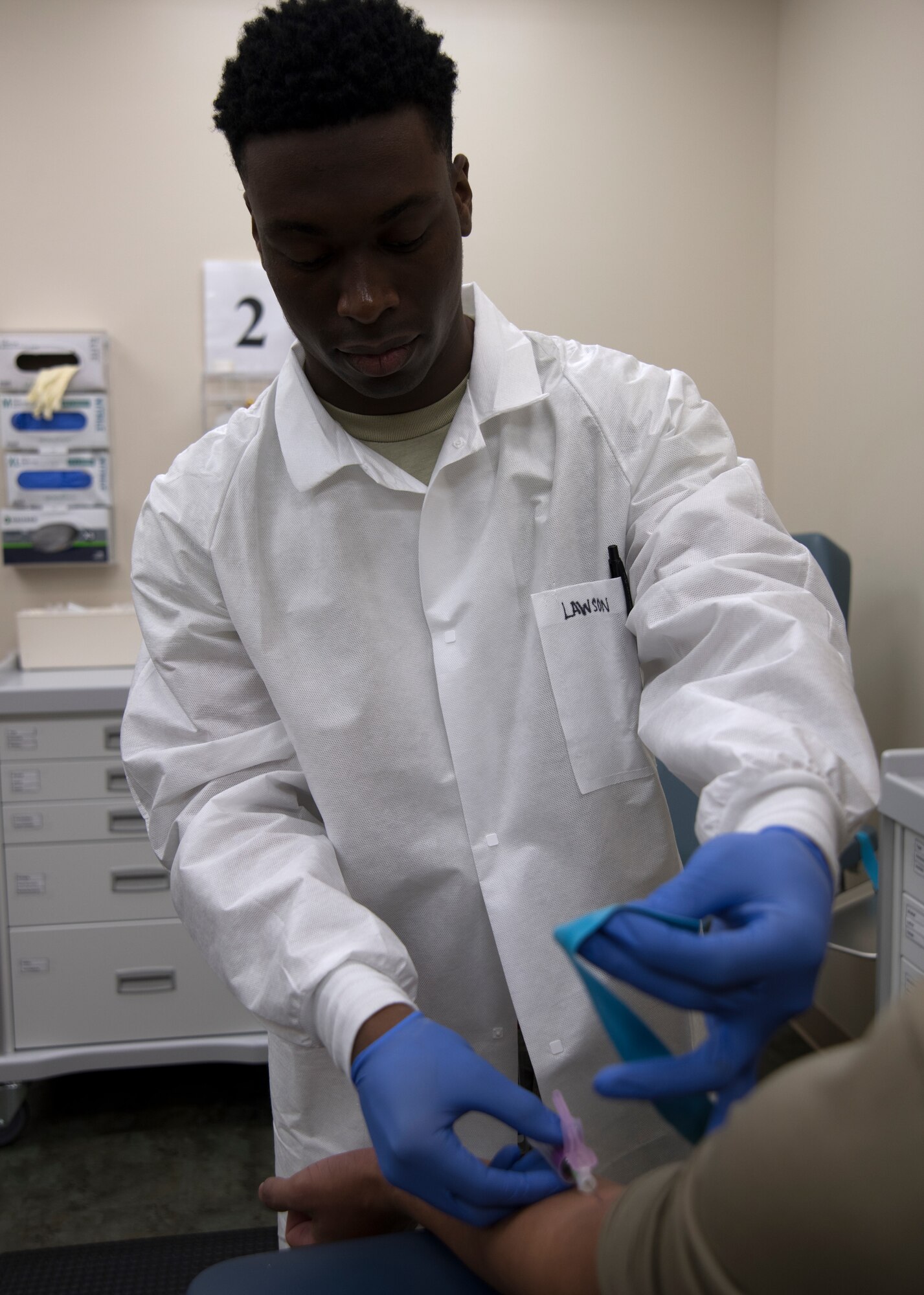 Photo of Airman drawing blood in the medical clinic