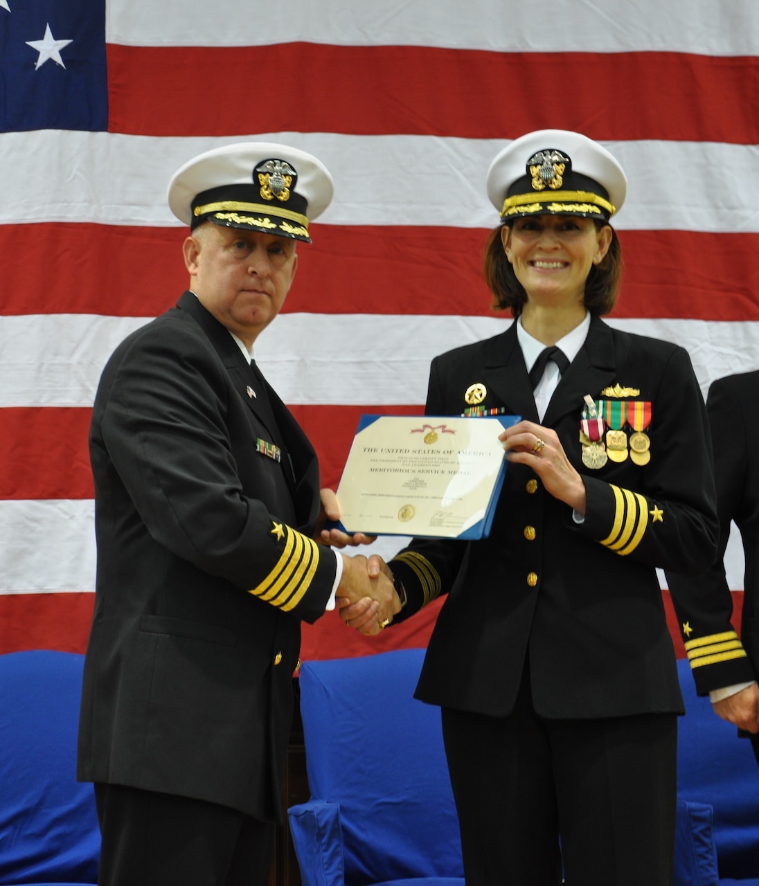 SASEBO, Japan (Dec. 12, 2019) Capt. Ed Thompson, deputy commander of Expeditionary Strike Group (ESG) 7, presents the Meritorious Service Medal to Cmdr. Greta Densham during the change of command ceremony for Naval Beach Unit (NBU) 7 onboard Commander, Fleet Activities Sasebo. Cmdr. Kirk Sowers relieved Densham as commanding officer. Under Densham’s leadership, the NBU 7 team completed eight forward-deployed naval forces (FDNF) deployments, 20 multi-lateral exercises, and two disaster relief efforts in the U.S. 7th Fleet area of responsibility. In November, the unit participated in Tiger Triumph, the first-ever tri-service exercise involving the U.S. Navy and Marine Corps and Indian Army, Navy and Air Force. NBU 7, part of Expeditionary Strike Group (ESG) 7, is operating in the Indo-Pacific region to enhance interoperability with partners and serve as a ready-response force for any type of contingency.