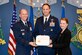 Air Force Vice Chief of Staff Gen. Stephen Wilson poses with Brig. Gen. Julian Cheater and his wife, Camila Cheater, during a ceremony to present the couple with the 2018 General and Mrs. Jerome F. O'Malley Award at the Pentagon in Arlington, Va., Nov. 13, 2019. The award annually recognizes a wing commander and his or her spouse who together best exemplify the ethos of Airmen-centric service. (U.S. Air Force photo by Andy Morataya)