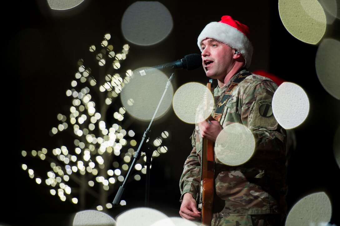 U.S. Army Staff Sgt. James Hosay, U.S. Army Training and Doctrine Command Band guitarist, sings along during the TRADOC band holiday concert at Joint Base Langley-Eustis, Virginia, Dec. 12, 2019.