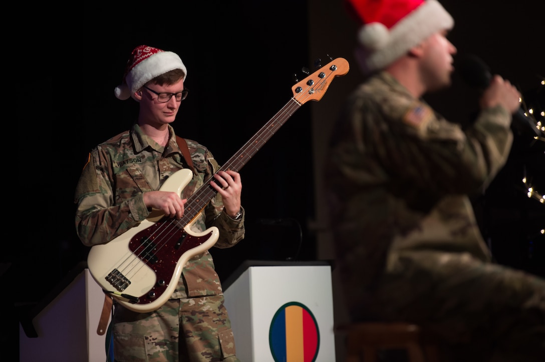 U.S. Army Spc. John Watson, U.S. Army Training and Doctrine Command Band bass guitarist, plays the bass during a holiday concert at Joint Base Langley-Eustis, Virginia, Dec. 12, 2019.