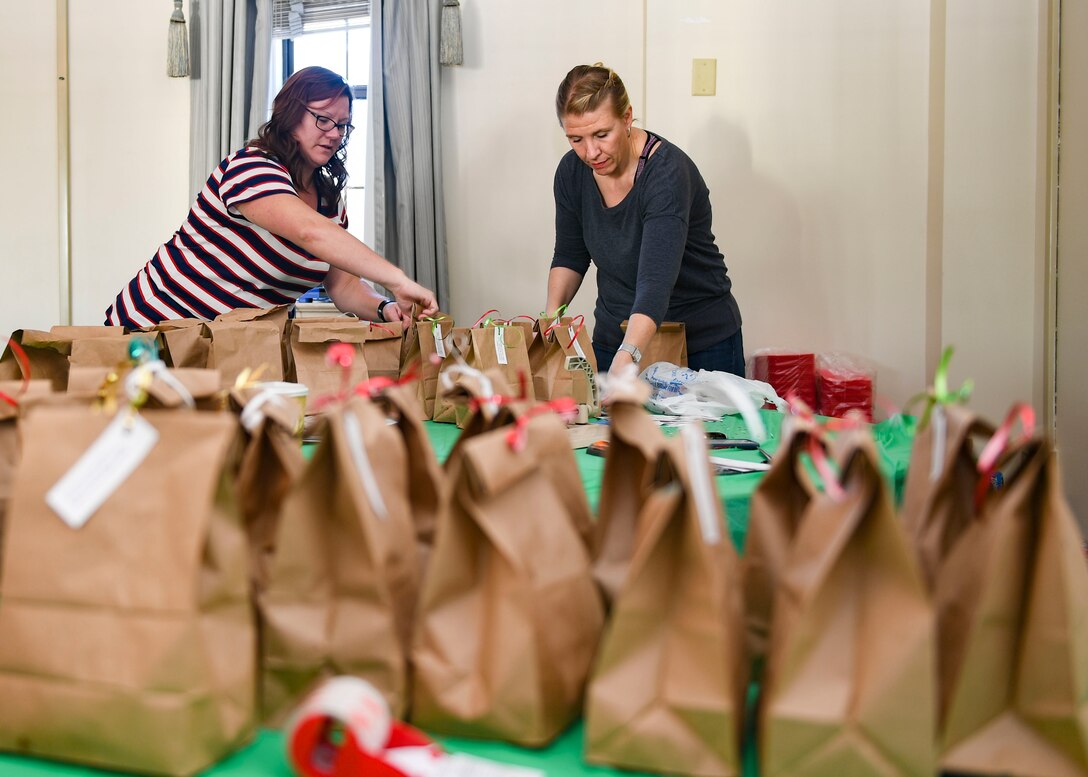 Langley Spouses Club members, prepare cookie bags for Airmen at Joint Base Langley-Eustis, Virginia, Dec. 12, 2019.