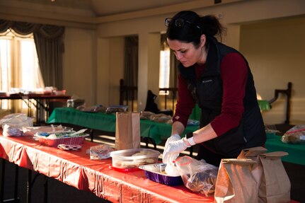 Kristi Ross, wife of Col. Clinton Ross, 633rd Air Base Wing commander, prepares a cookie bag for Airmen at Joint Base Langley-Eustis, Virginia, Dec. 12, 2019.