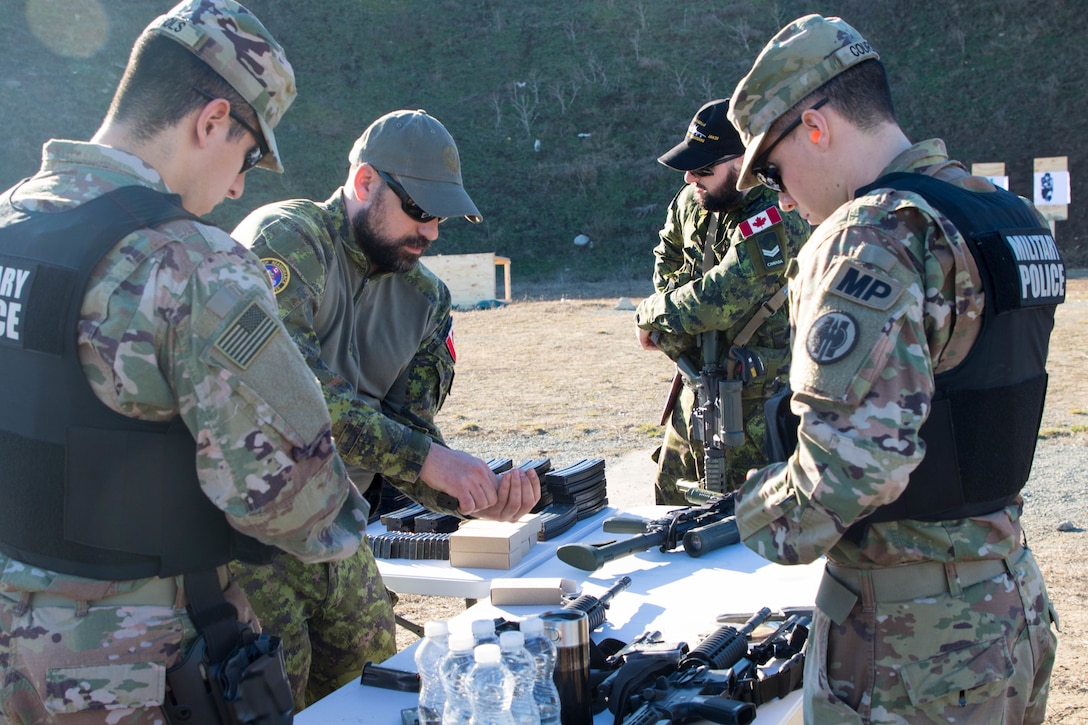 U.S. and Canadian military police conduct weapons training in Romania