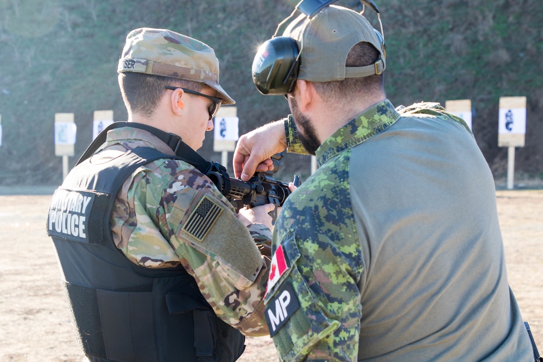 U.S. and Canadian military police conduct weapons training in Romania