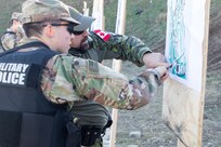 U.S. and Canadian military police conduct weapons training in Romania