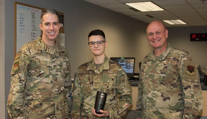 Photo of an Airman receiving the Weasel of the Week award